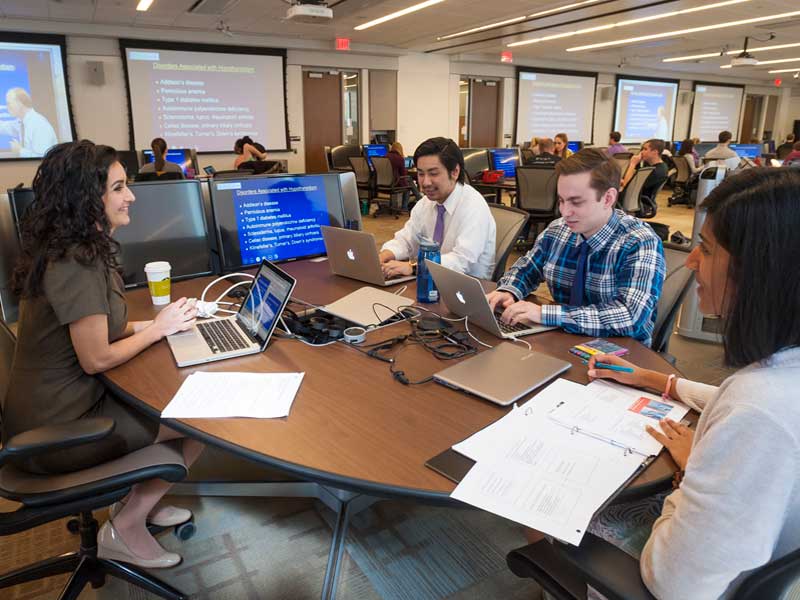 employees working collaboratively around a conference table